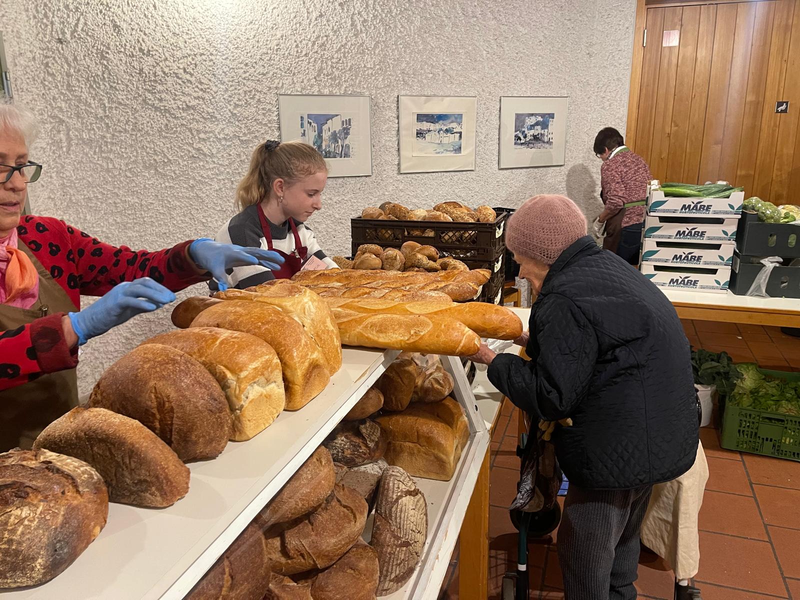 a group of people standing in a bakery